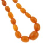 An amber and resin graduated bead necklace.Amber is untested.Diameter of beads 1.5 to 3.1cms.