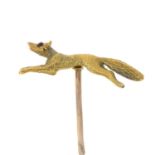 An early 20th century 15ct gold stickpin depicting a leaping fox with garnet eyes.Stamped