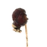 A late 19th century 9ct gold carved smoky quartz profile stickpin.Length of stickpin head 1.1cms.