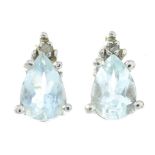 A pair of aquamarine and diamond stud earrings.Stamped 14k.Length of earrings 0.8cms.