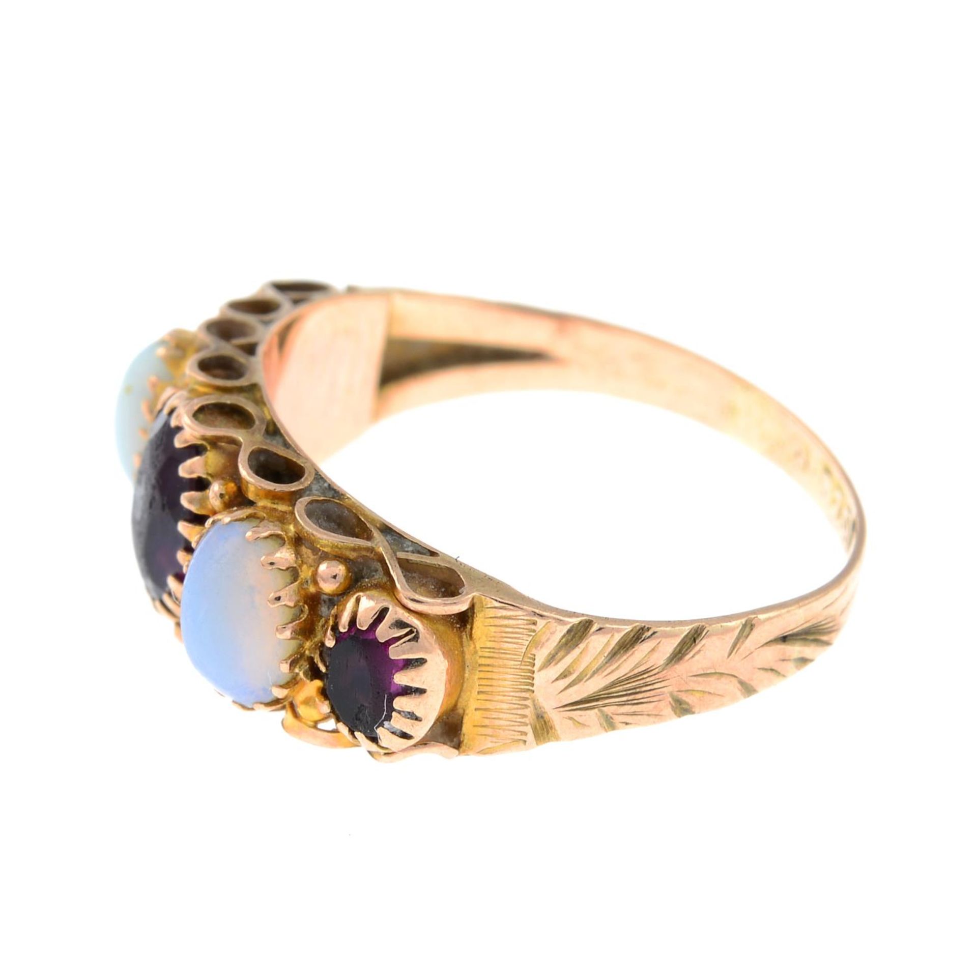 An early 20th century garnet and opal ring.Stamped 375.Ring size F. - Image 2 of 3