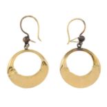 A pair of circular drop earrings.