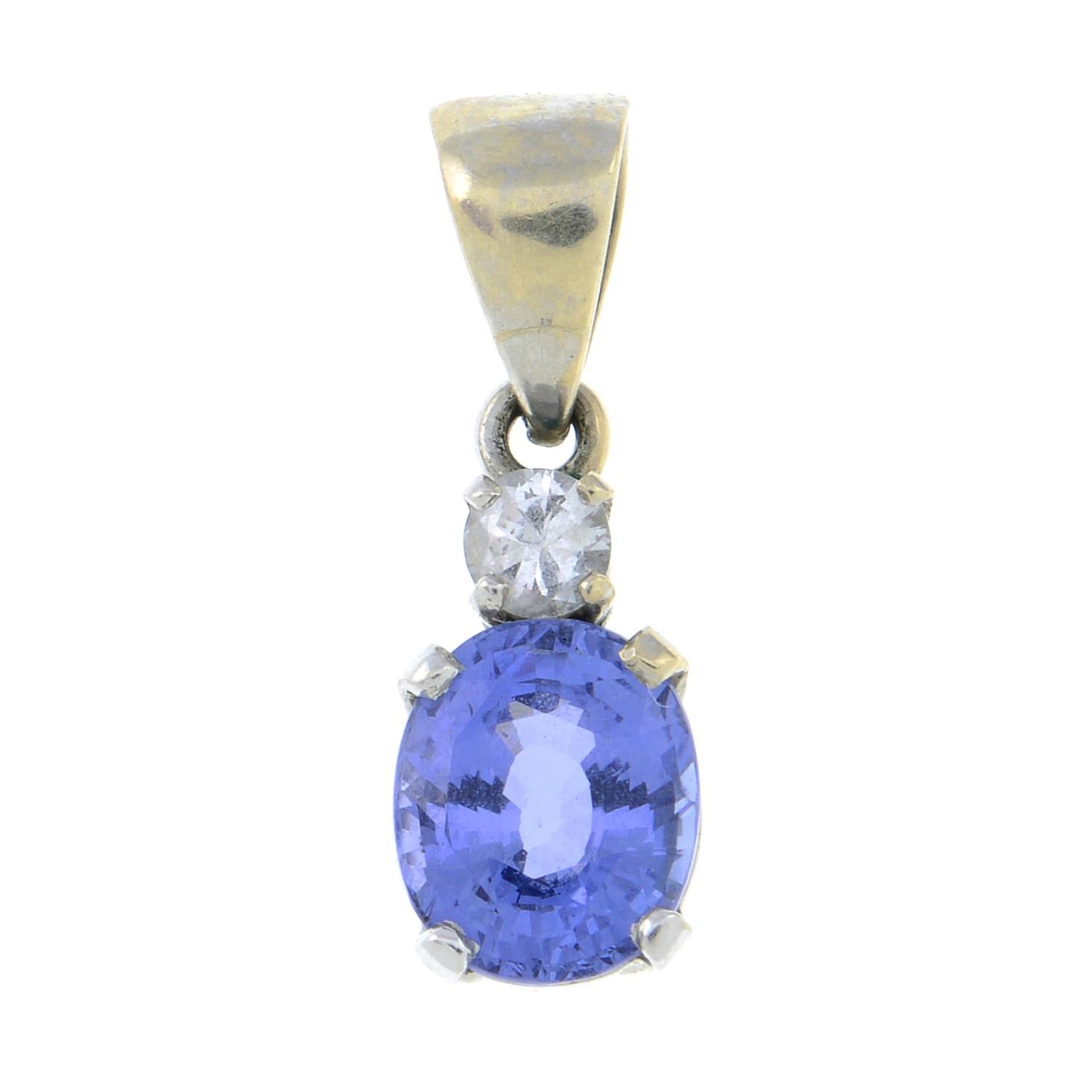 A sapphire and diamond pendant.Estimated diamond weight 0.1cts.Stamped 585.Length 1.8cms.