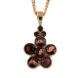 A garnet pendant of a flower,