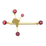 A garnet topped doublet Africa Southern cross brooch.Stamped 9ct.Length 4.9cms.