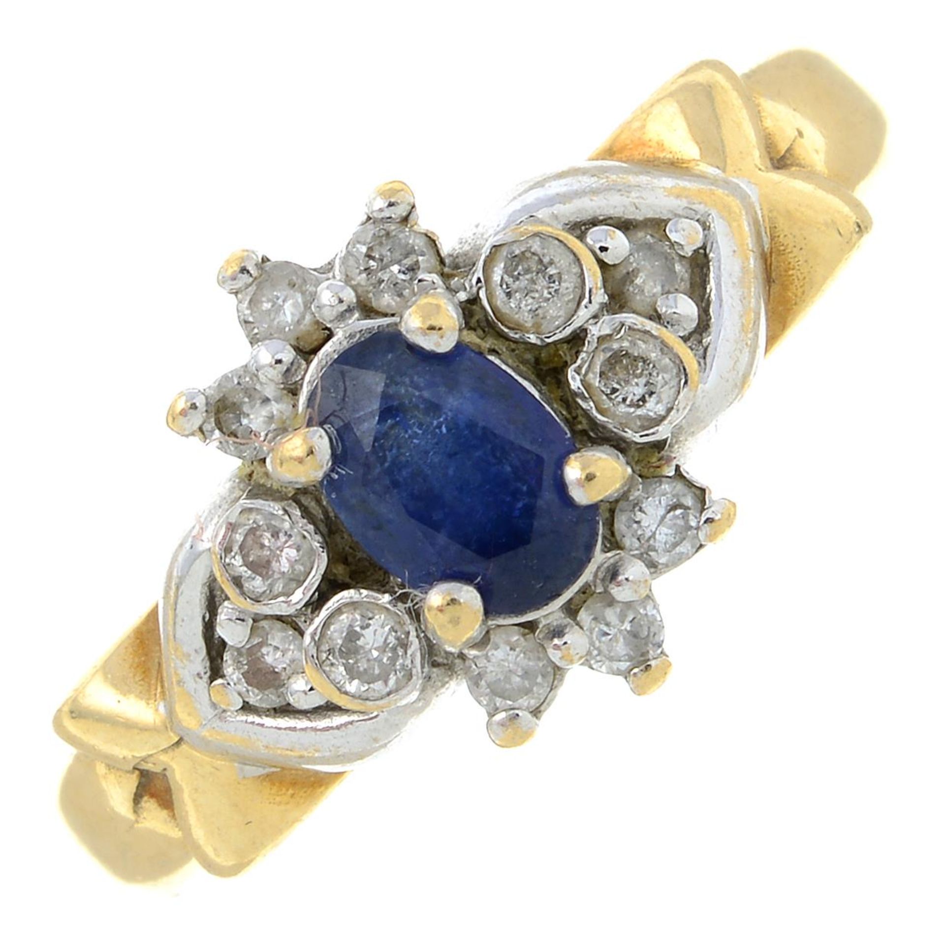 A 9ct gold sapphire and brilliant-cut diamond cluster ring.Estimated total diamond weight