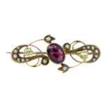 An early 20th century 9ct gold garnet, peridot and split pearl brooch.Stamped 9ct.Length 3.8cms.