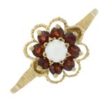 A 9ct gold opal cabochon and garnet cluster ring.Hallmarks for Birmingham.Ring size Y.