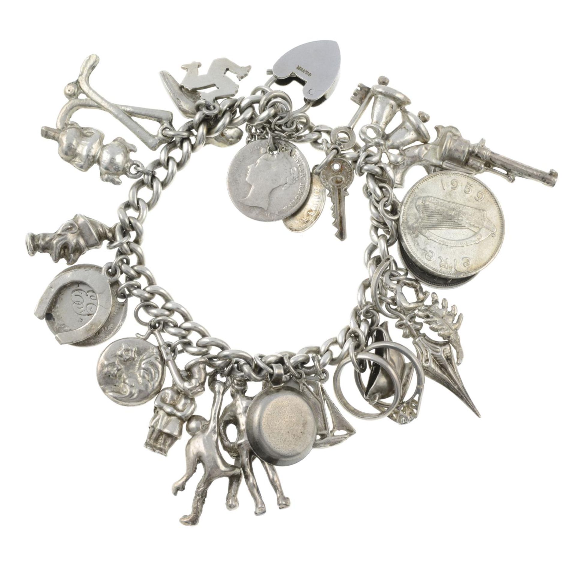 A charm bracelet with assorted charms.Many with marks to indicate silver.Length 17.8cms. - Image 2 of 2