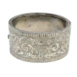 A late Victorian engraved hinge bangle.Inner diameter 5.7cms.