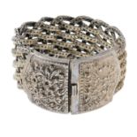 A Thai woven bracelet with chased floral clasp.Stamped 925.Length 20cms.