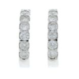 A pair of diamond hoop earrings.Estimated total diamond weight 0.35cts.Stamped 375.Length 1.3cms.