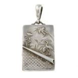 A late Victorian silver locket featuring a crane and parrot motif.Length 6cms.