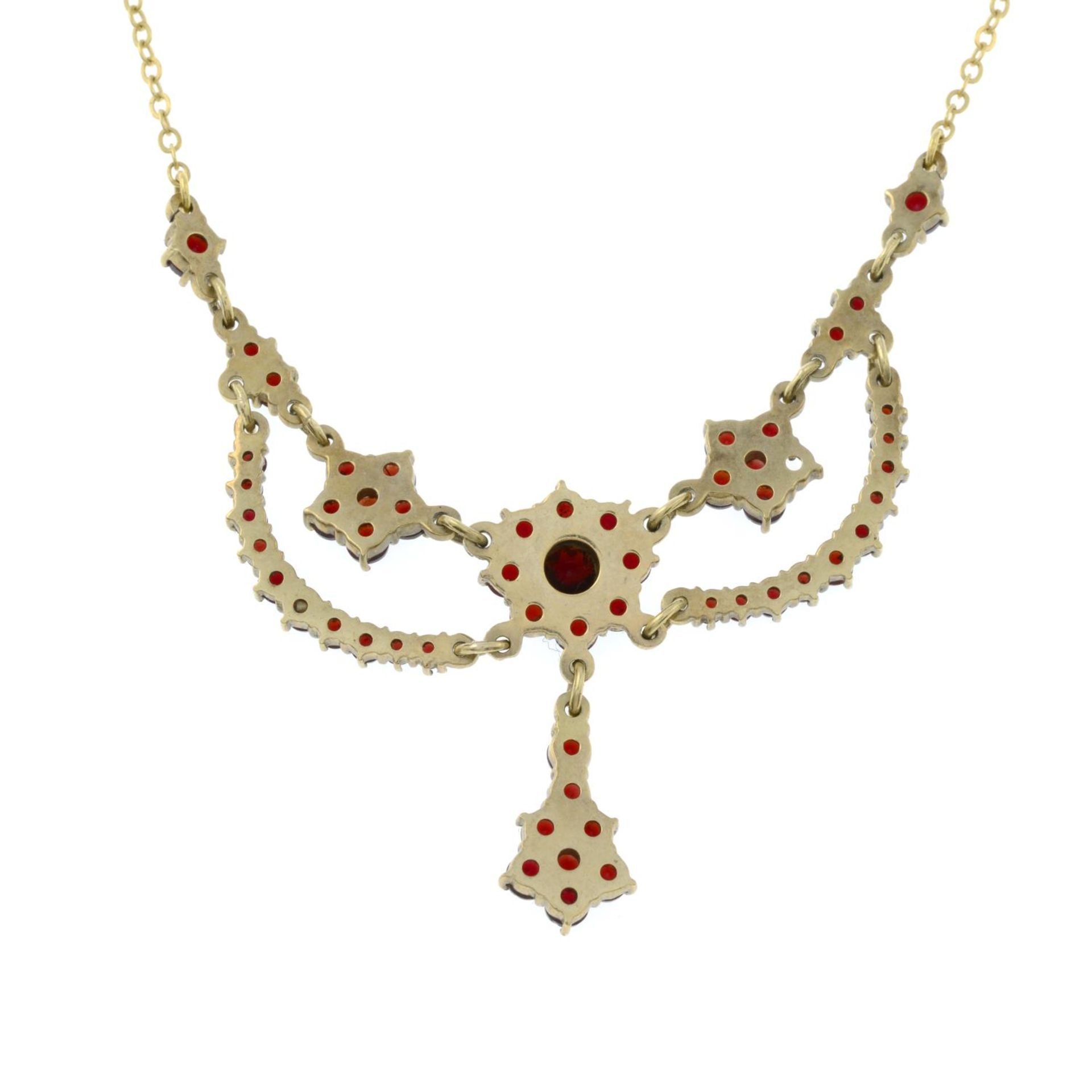 A bohemian garnet floral necklace.Stamped 9ct.Length 42cms. - Image 3 of 3