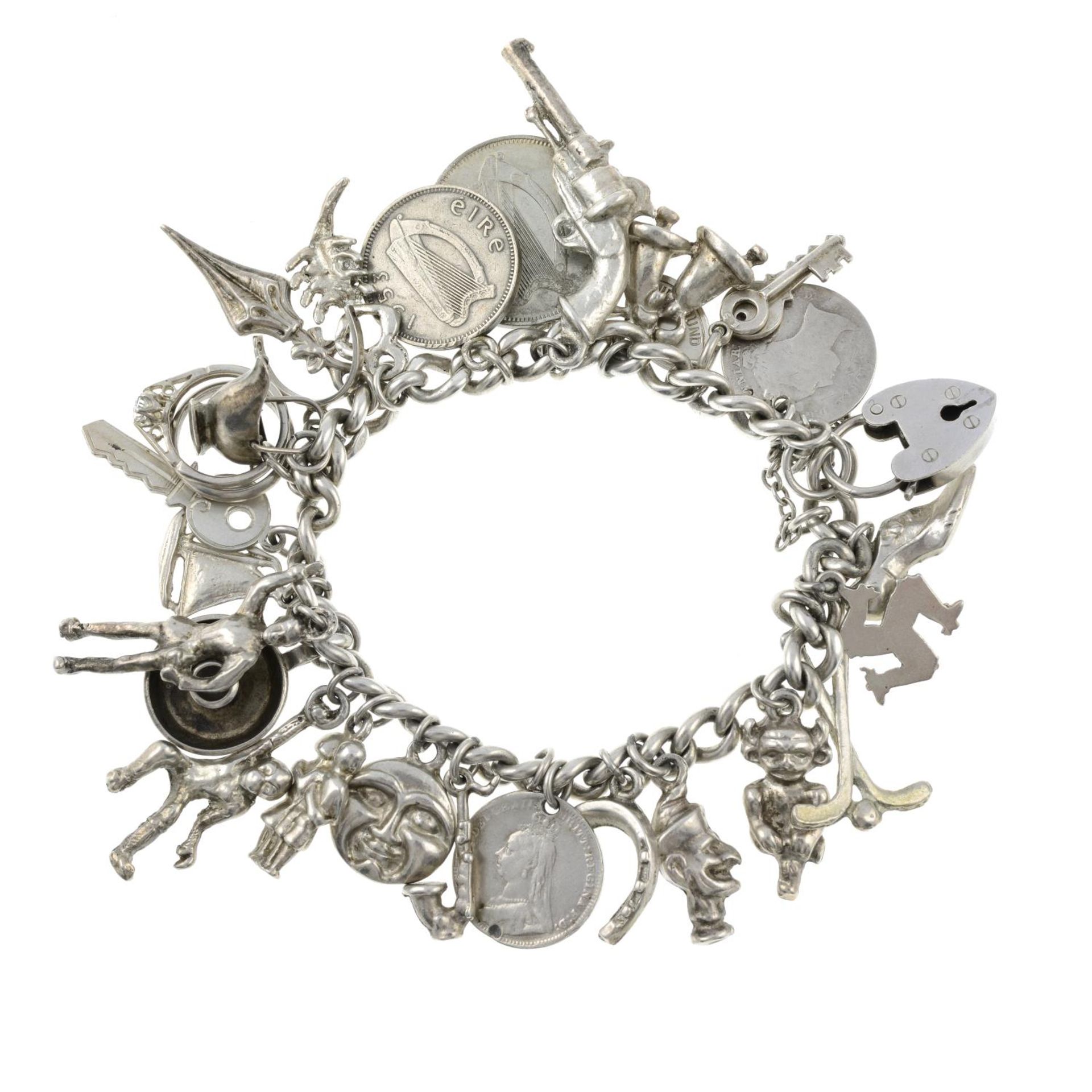 A charm bracelet with assorted charms.Many with marks to indicate silver.Length 17.8cms.