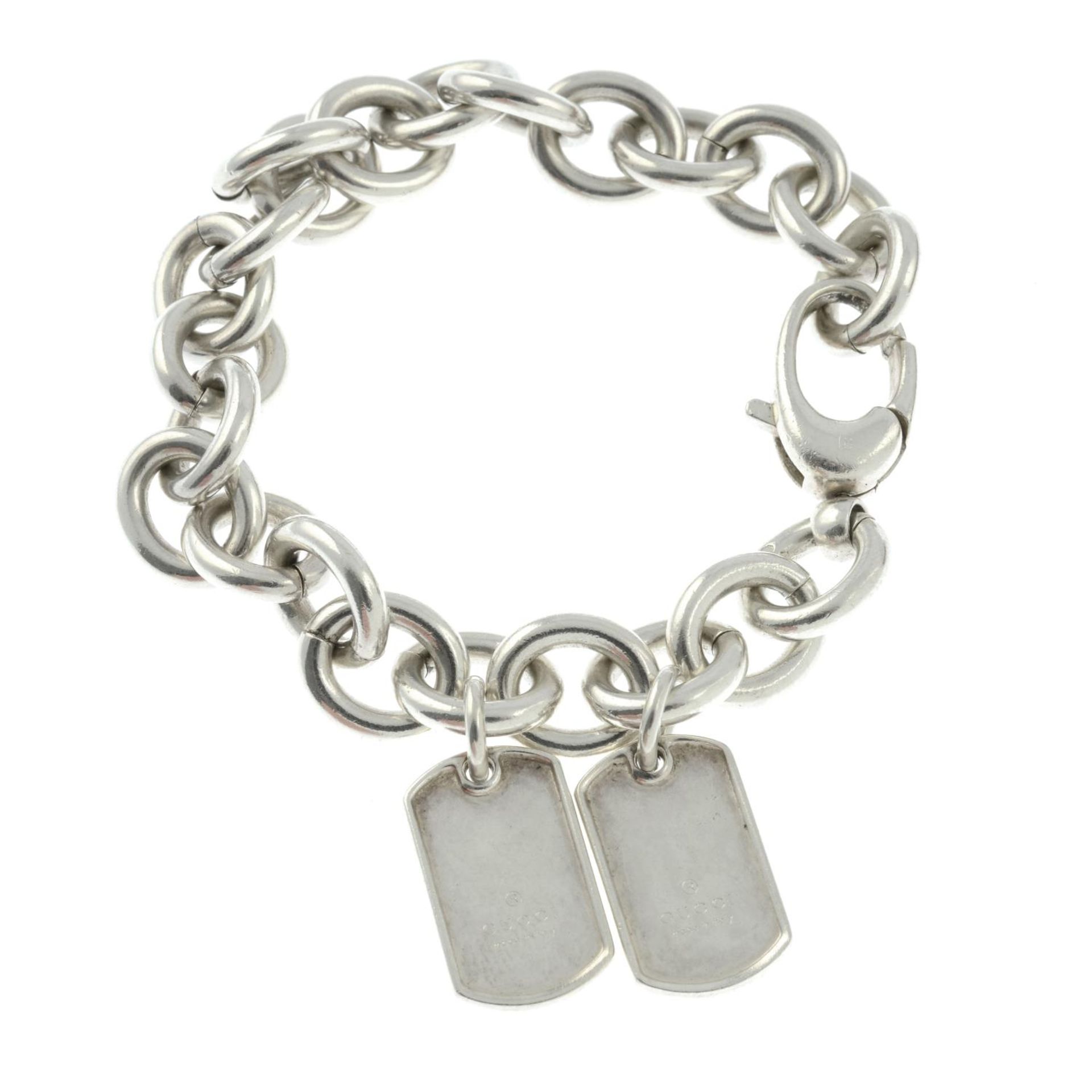 A silver bracelet with two tags charms, by Gucci.Signed Gucci.