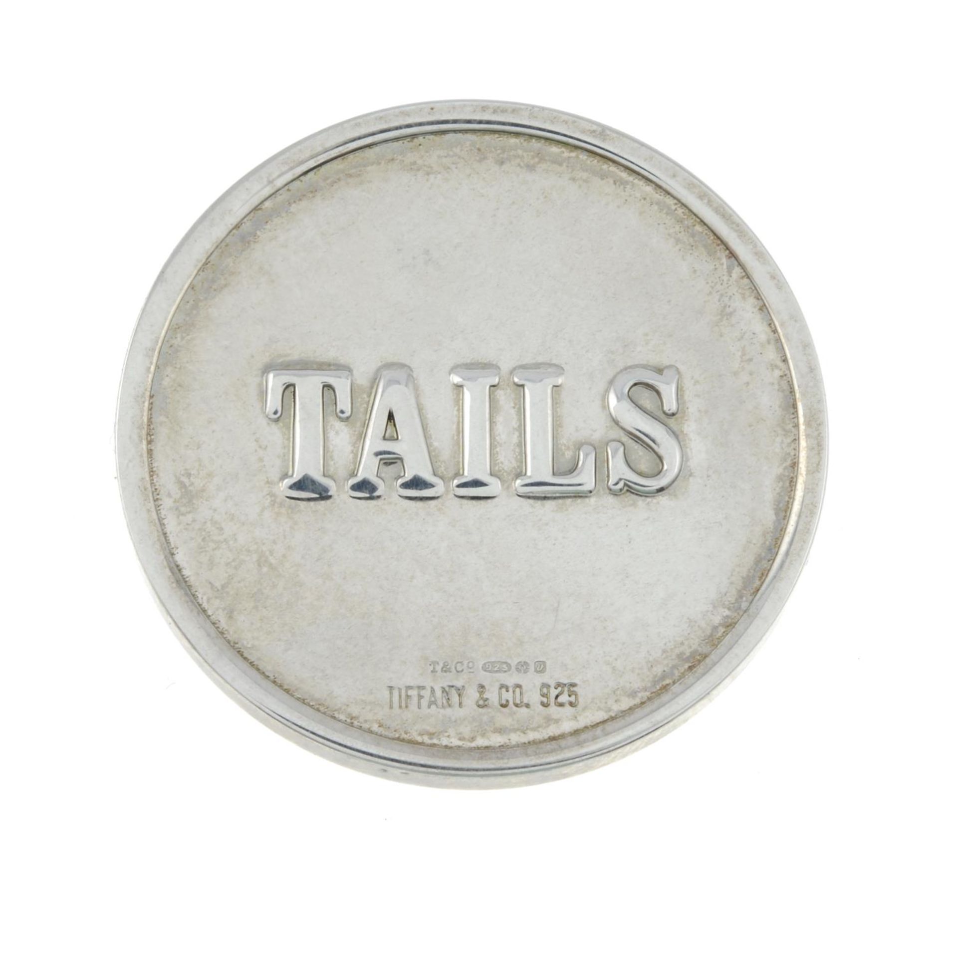 A silver coin, by Tiffany & Co.