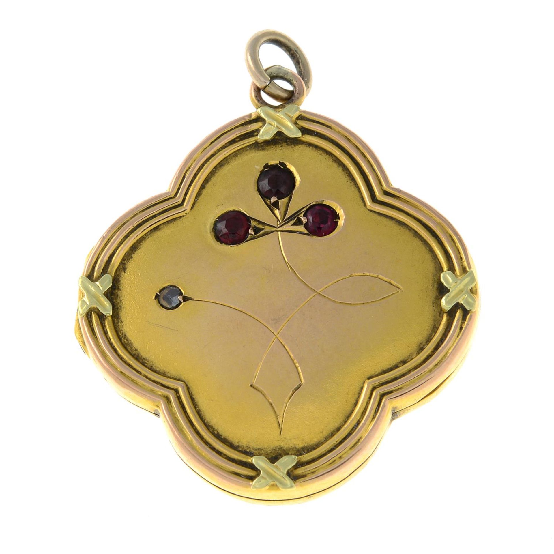 A late Victorian gold garnet and diamond floral locket.Length 3.2cms.