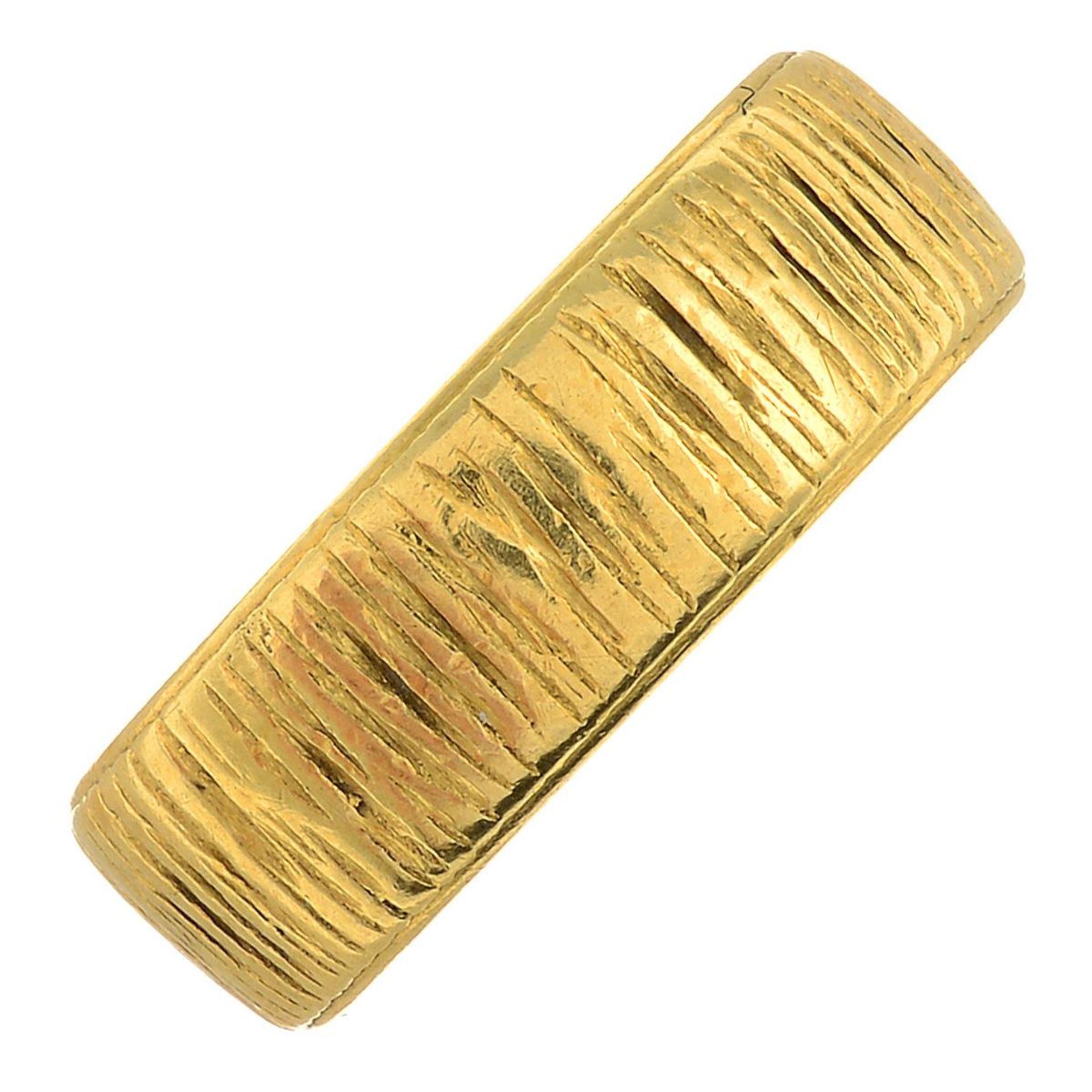 An 18ct gold textured band ring.Hallmarks for London, 1973.Ring size M1/2.