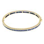 A sapphire hinged bangle, with diamond push-piece clasp.Diamond estimated weight 0.10ct.