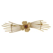 A 9ct gold garnet stylised flower brooch.Hallmarks for 9ct gold.