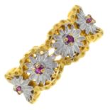 A ruby accent openwork bi-colour ring, with floral motif.Stamped 18K 750.