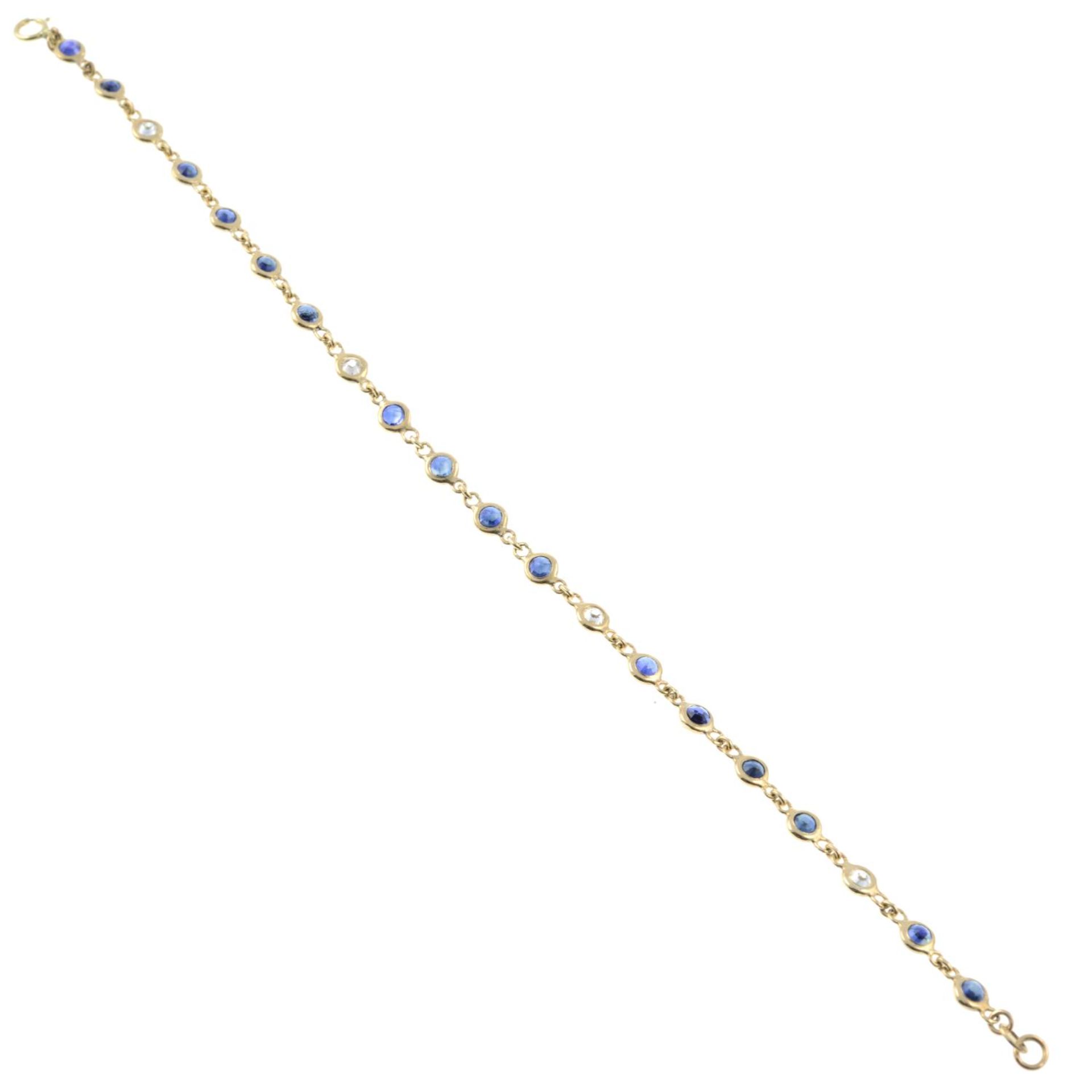 A sapphire and diamond line bracelet.Estimated total diamond weight 0.40ct. - Image 2 of 2