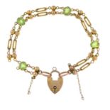 An early 20th century peridot bracelet, with heart padlock clasp.AF.