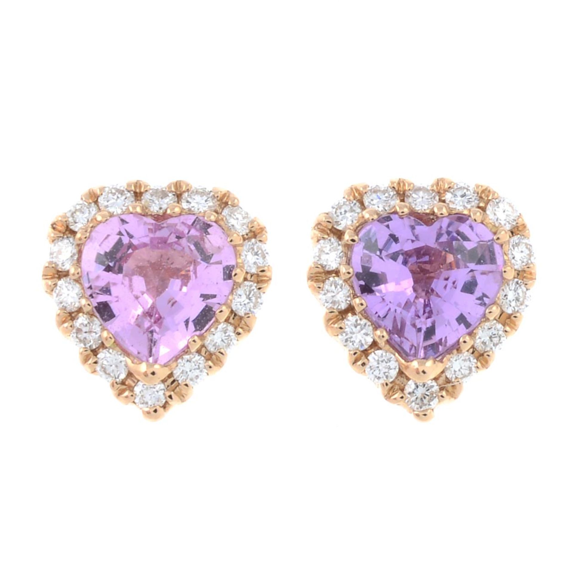 A pair of pink sapphire and diamond heart-shape earrings.Total sapphire weight 0.78ct,