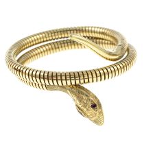 A 1950s 9ct gold coiled snake bangle,