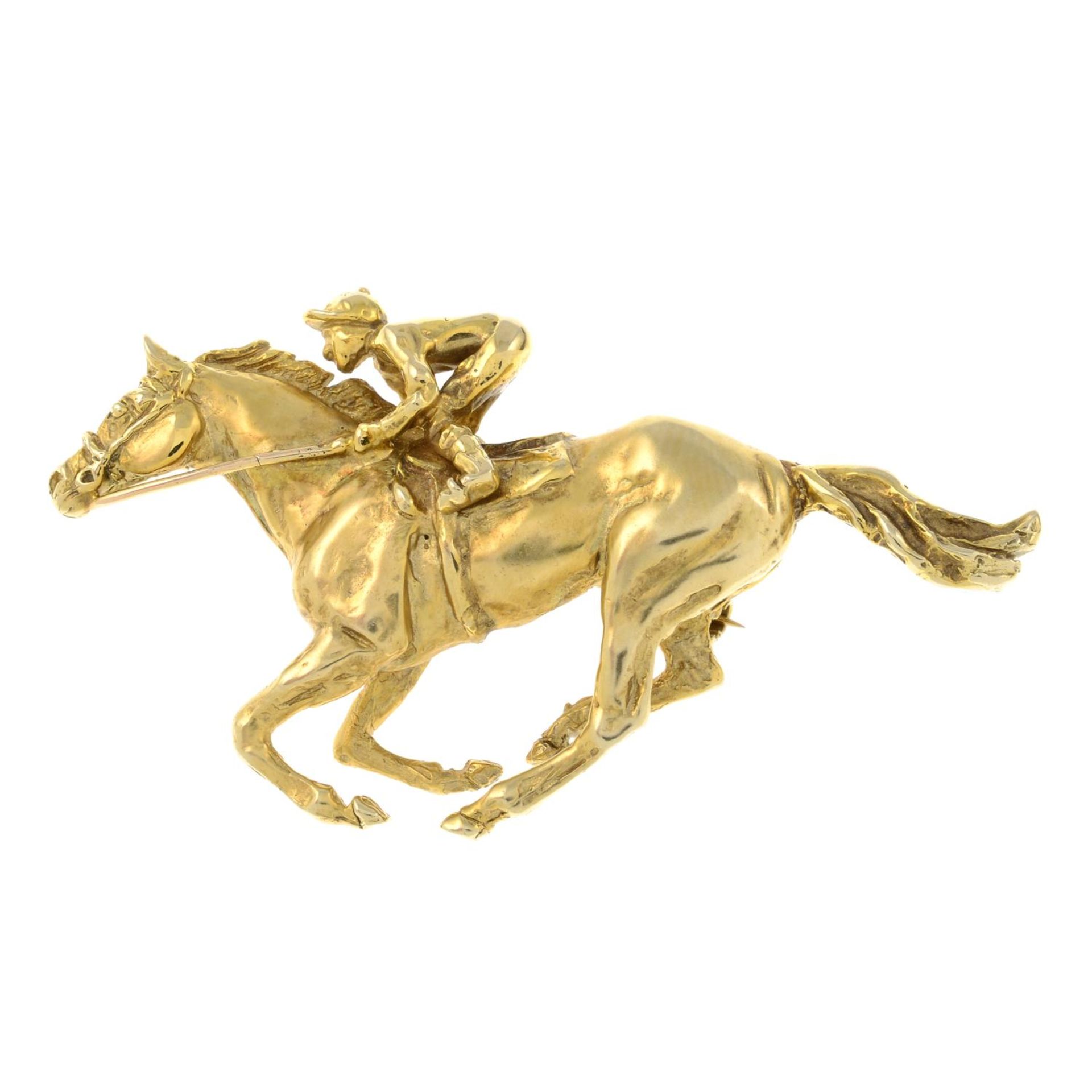 A 9ct gold jockey and horse brooch.Hallmarks for London, 2001.Length 4.9cms.