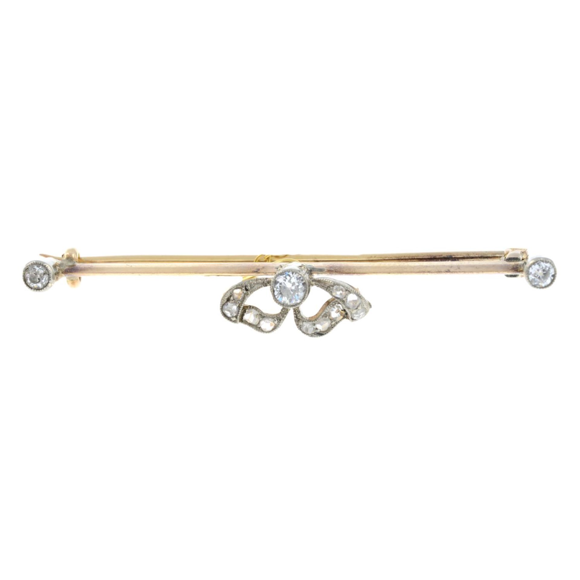 An early 20th century gold vari-cut diamond bar brooch.Estimated total old-cut diamond weight