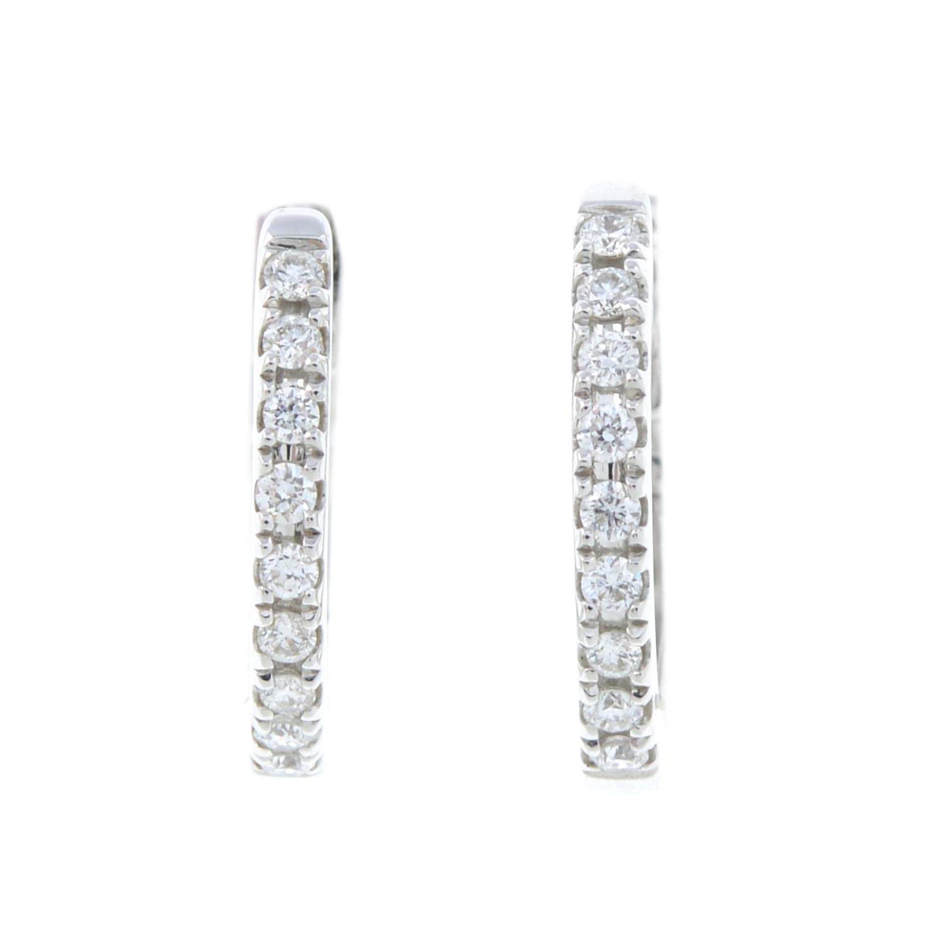 A pair of brilliant-cut diamond hoop earrings.Total diamond weight 0.28ct, stamped to band.