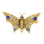 An early 20th century gold sapphire, split pearl and garnet butterfly brooch.Length 3.2cms.