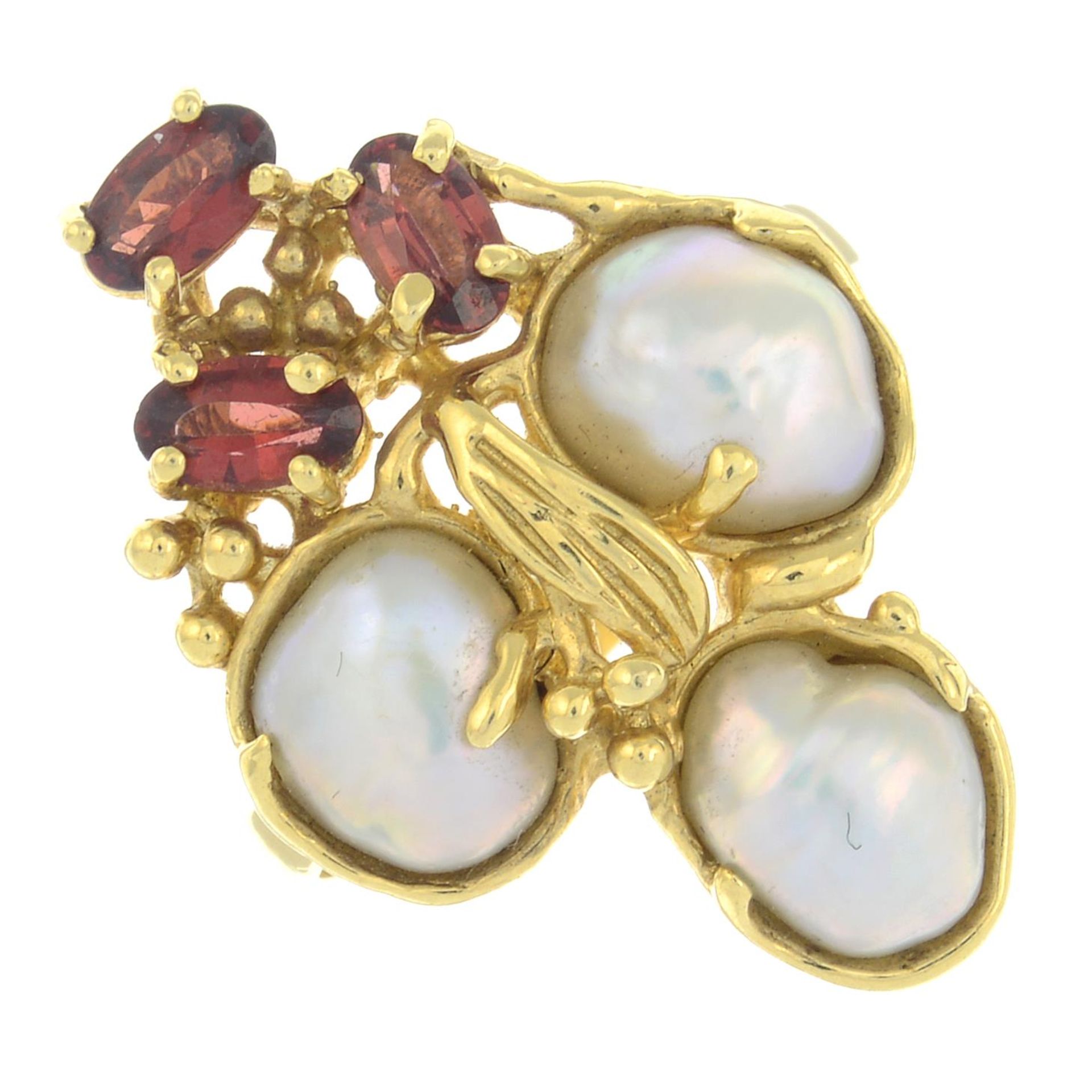 A mother-of-pearl and garnet cluster ring.