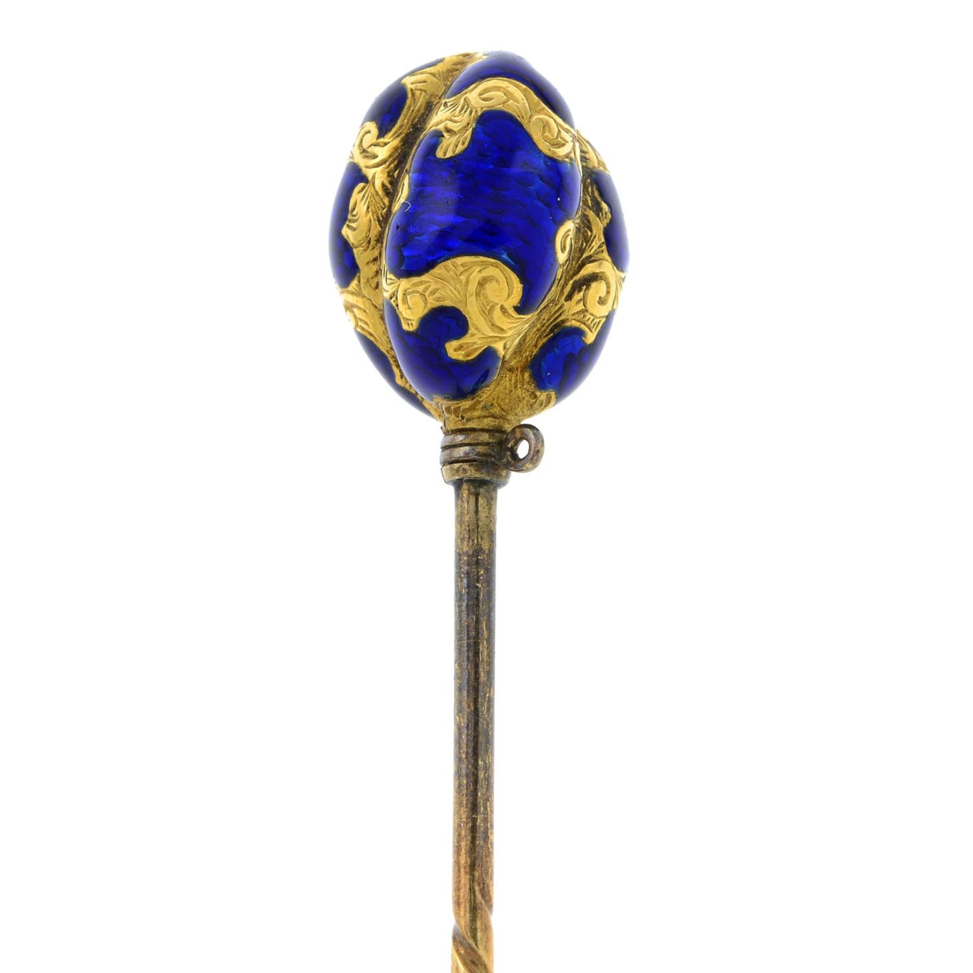 An early 20th century gold and blue enamel stickpin,