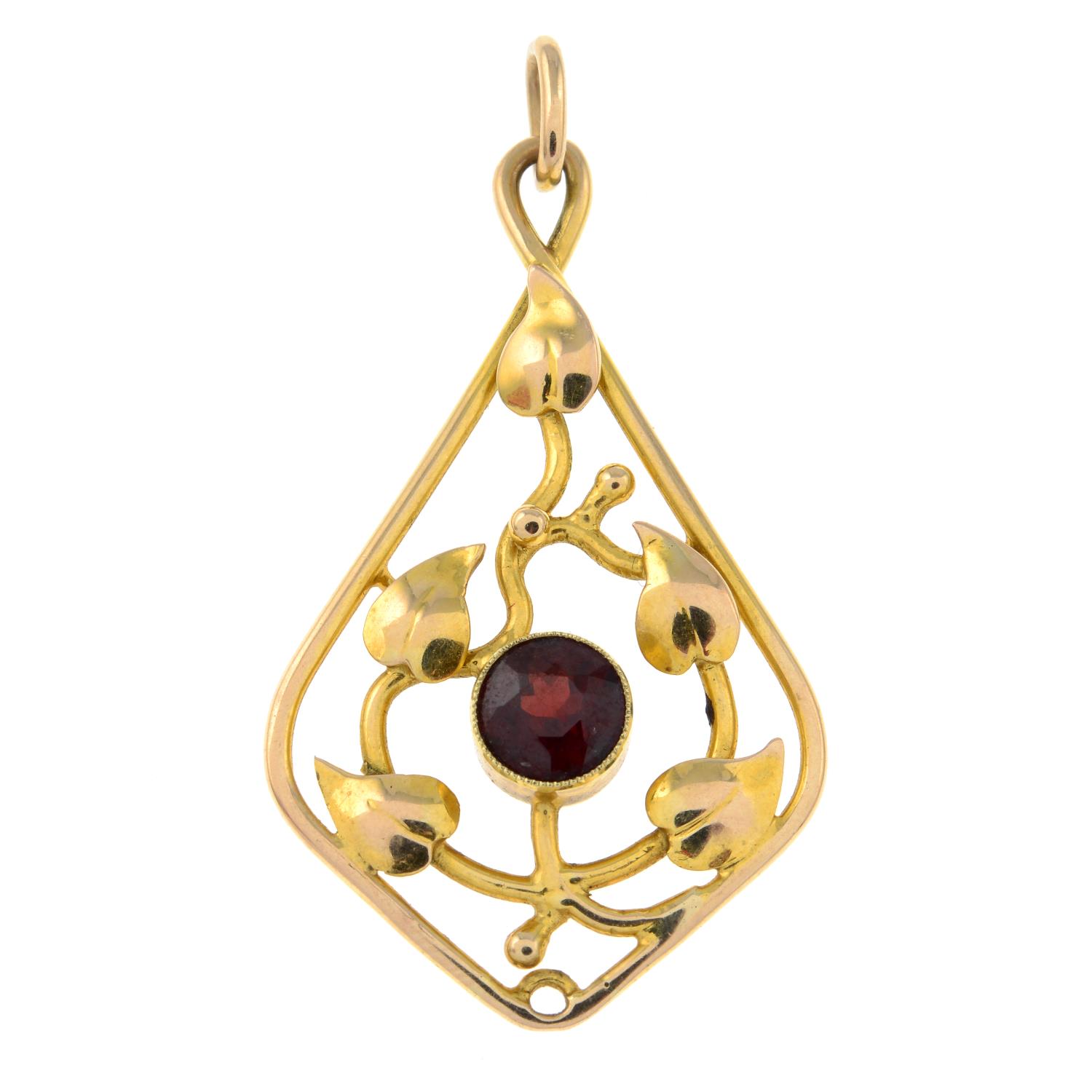 An early 20th century gold garnet foliate pendant.Length 4.6cms.