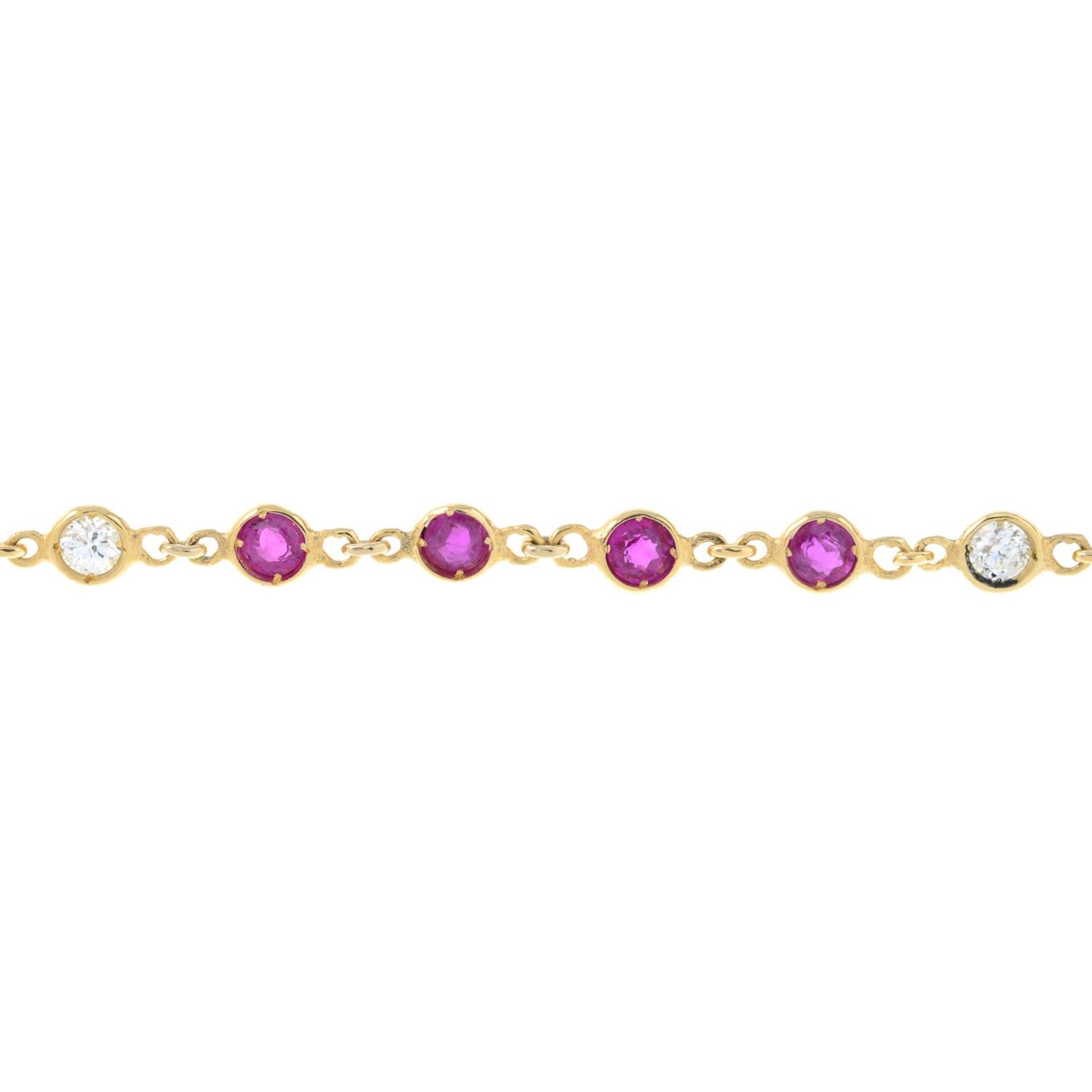 A ruby and diamond line bracelet.Estimated total diamond weight 0.40ct.