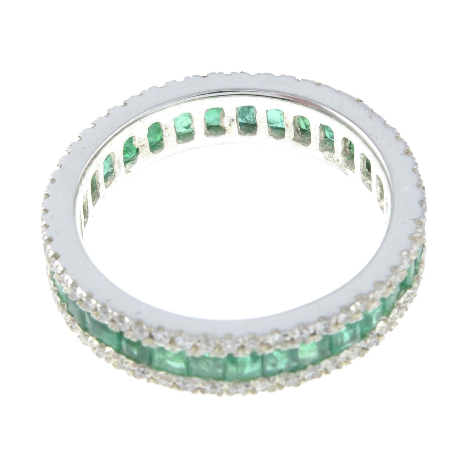 An emerald and diamond full eternity ring.Estimated total diamond weight 0.50ct. - Image 2 of 2