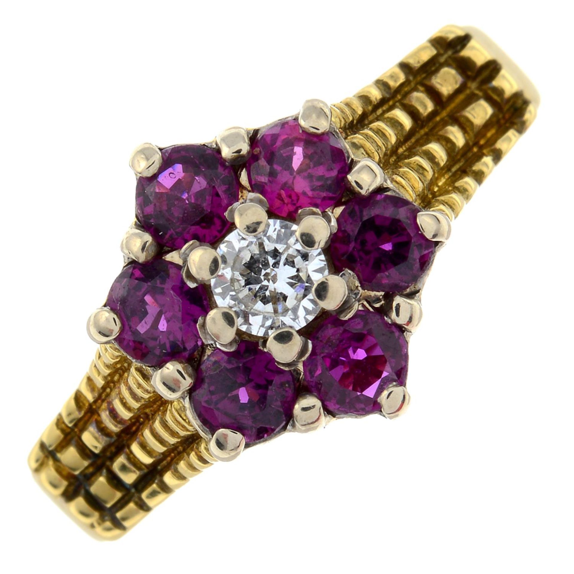 A diamond and ruby floral cluster ring.Diamond estimated weight 0.15ct, H-I colour, VS clarity.