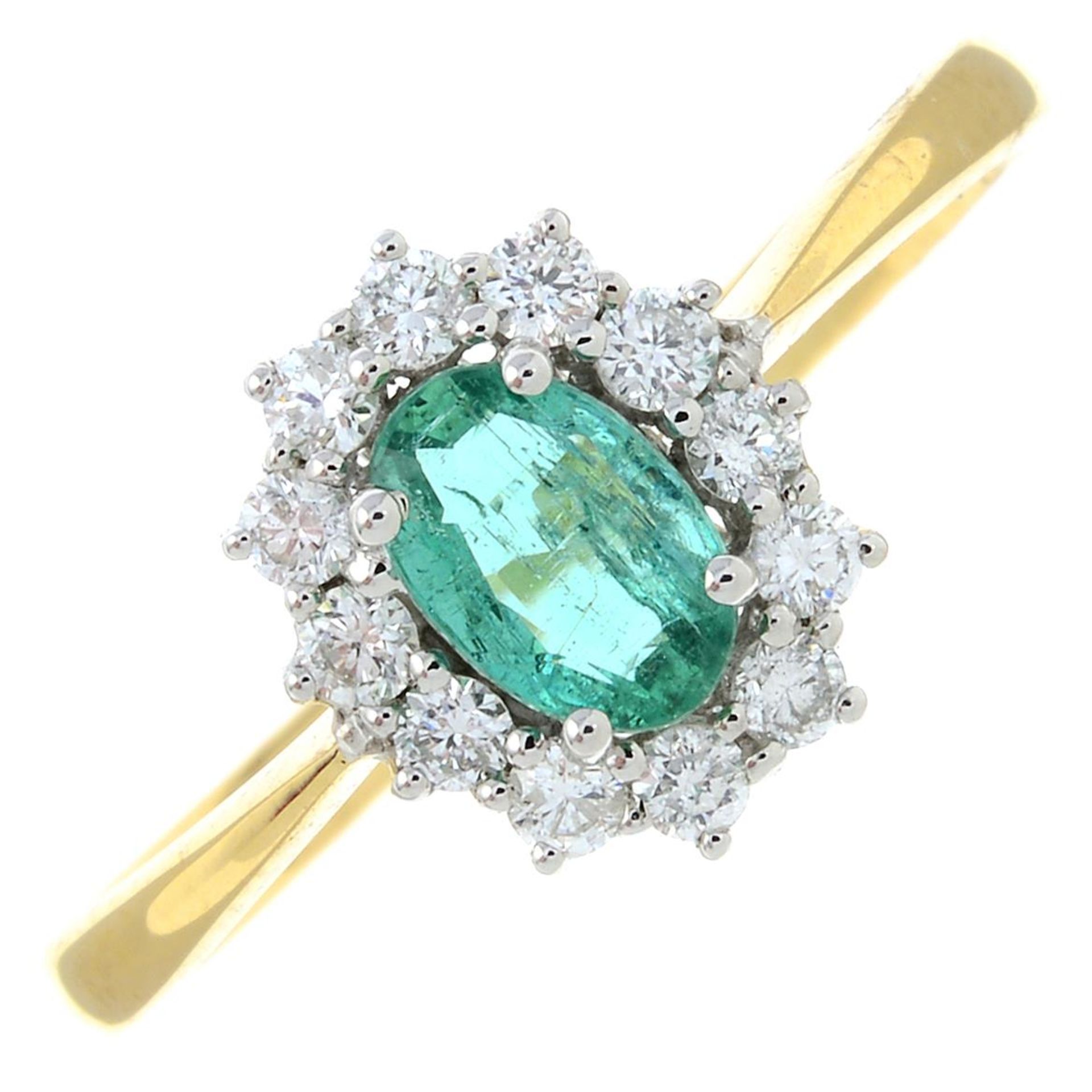 An 18ct gold emerald and diamond cluster ring.Emerald weight 0.40ct.