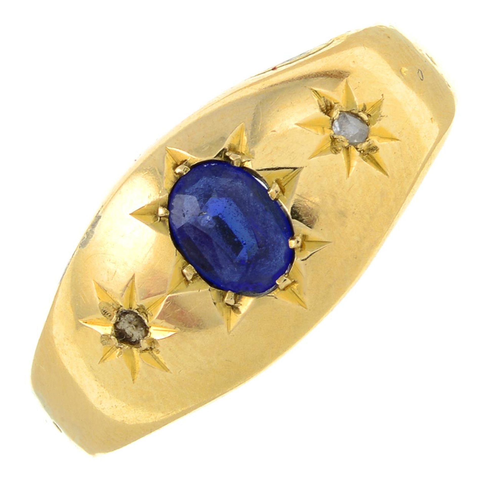 An early 20th century 18ct gold blue garnet-topped-doublet and rose-cut diamond three-stone