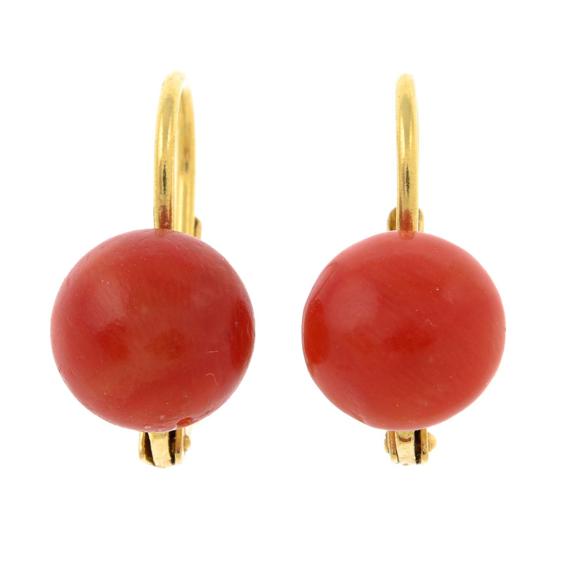 A pair of coral earrings.Stamped 750.