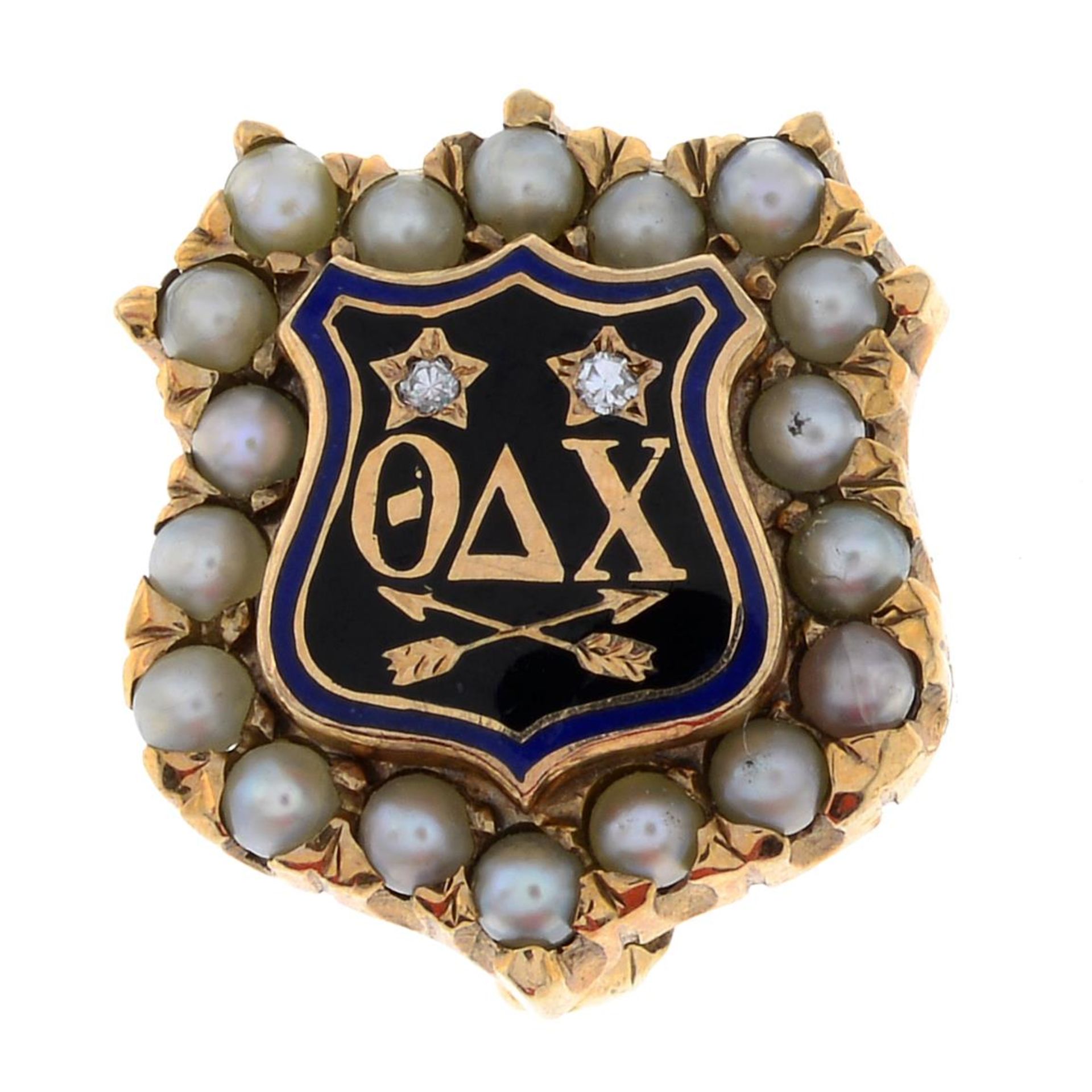 An American split pearl, diamond and enamel fraternity pin for Theta Delta Chi.Length 1.3cms.