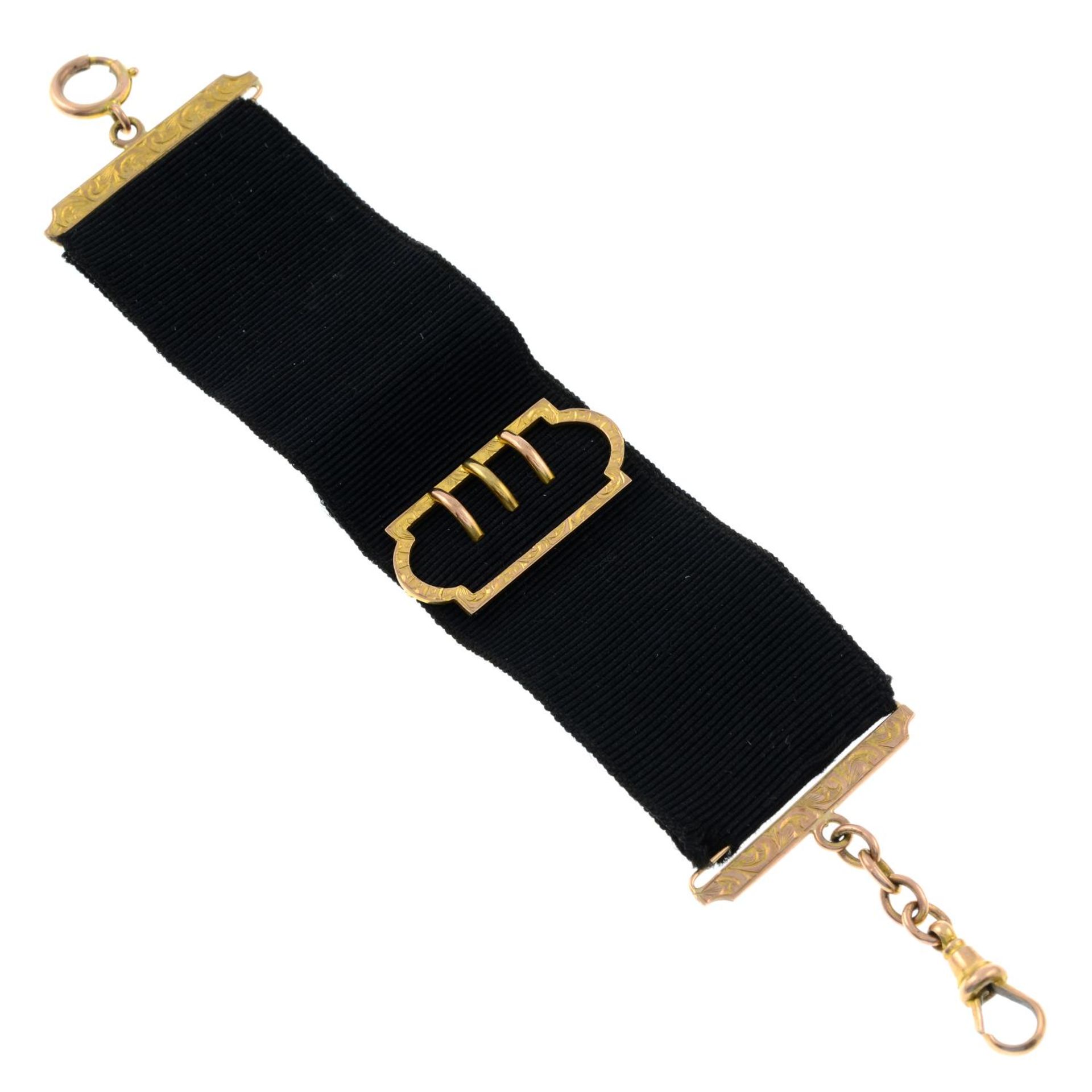 A late 19th century 9ct gold watch fob belt, with buckle motif.Stamped 9CT.