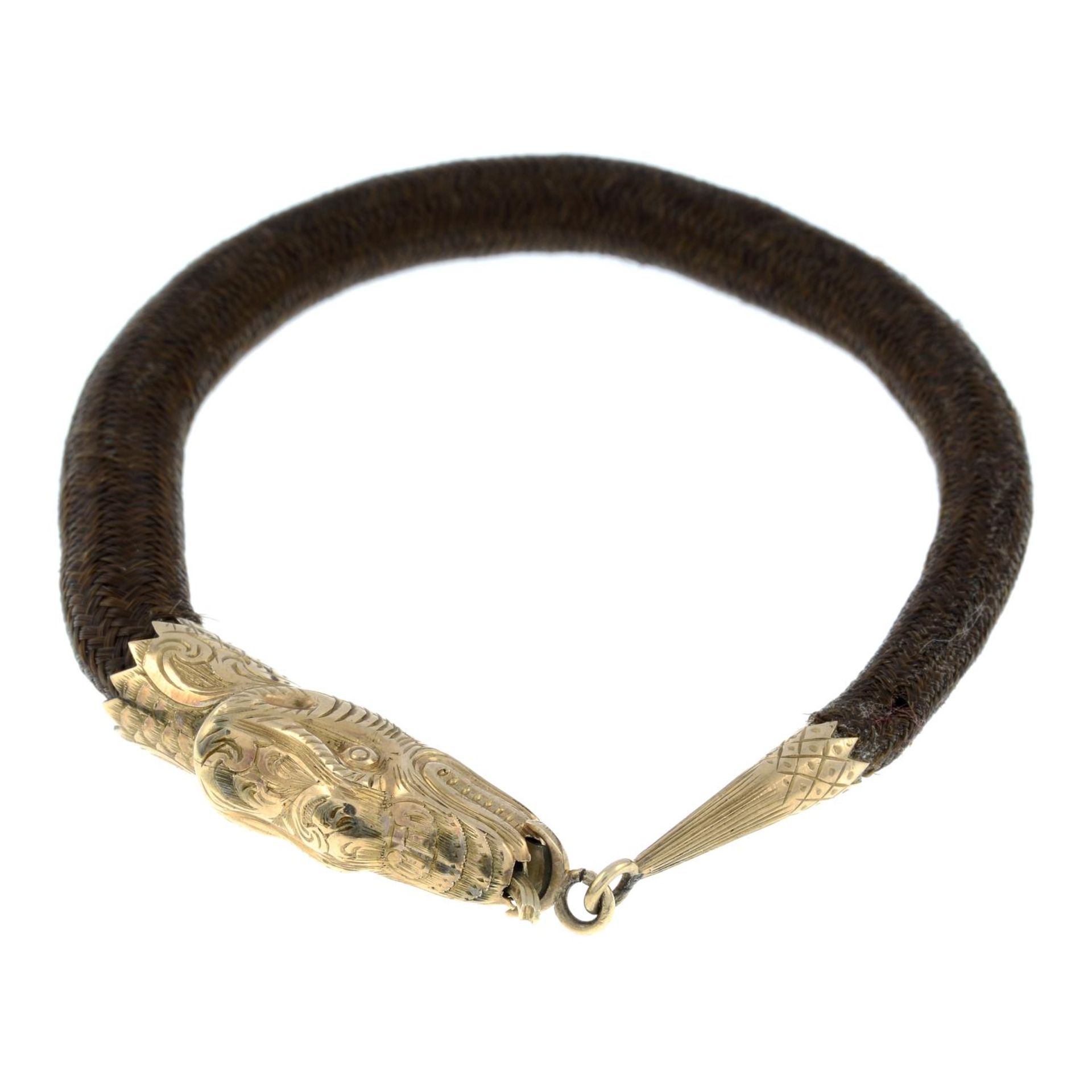 A late Victorian gold woven hairwork memorial bracelet, designed to depict a snake.Length 17.5cms.