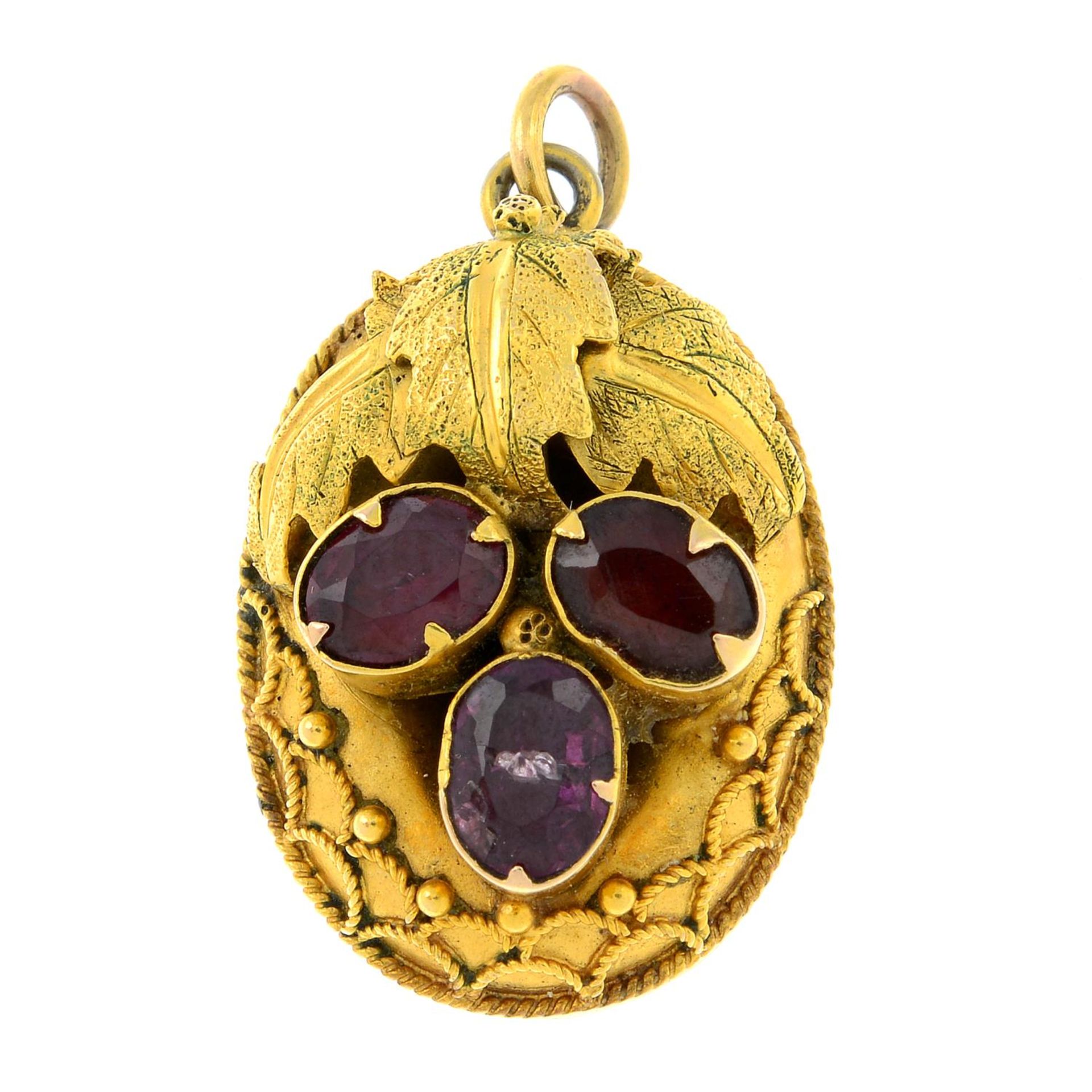 A late 19th century gold garnet memorial pendant.Length 2.7cms.