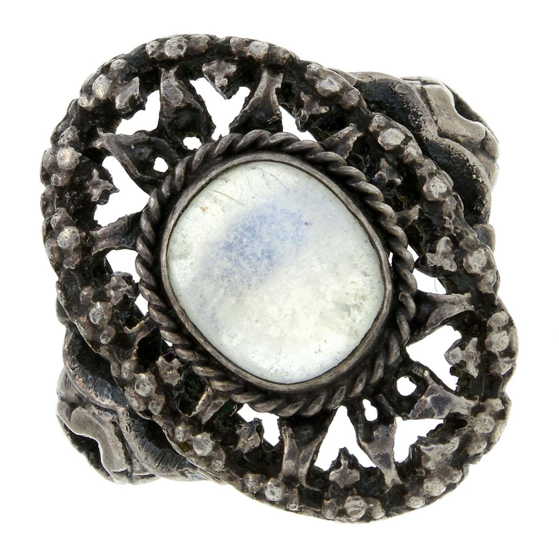 An Arts and Crafts silver moonstone single-stone ring, in the manner of Sybil Dunlop.Ring size N.