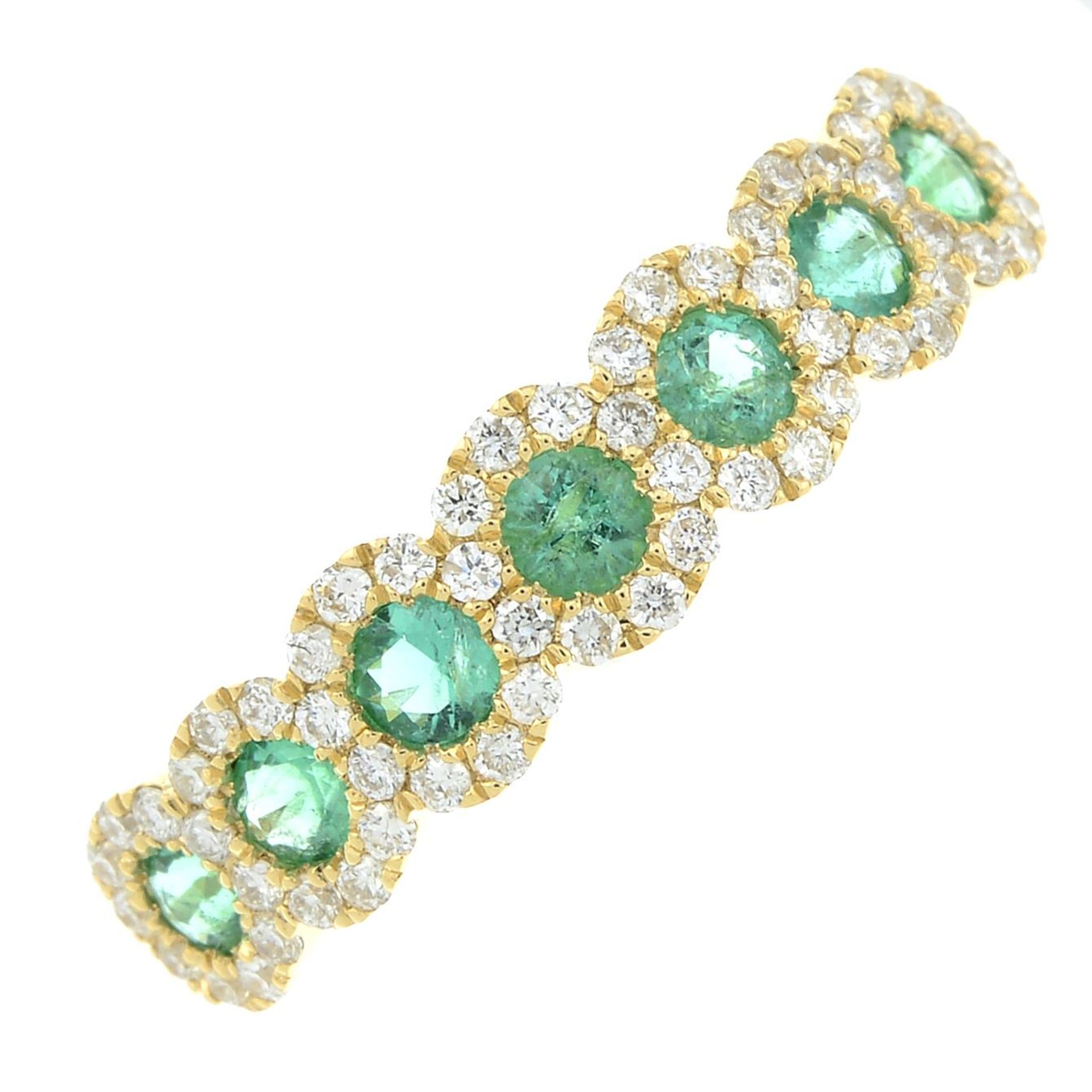 An 18ct gold emerald and brilliant-cut diamond half eternity ring.Total diamond weight