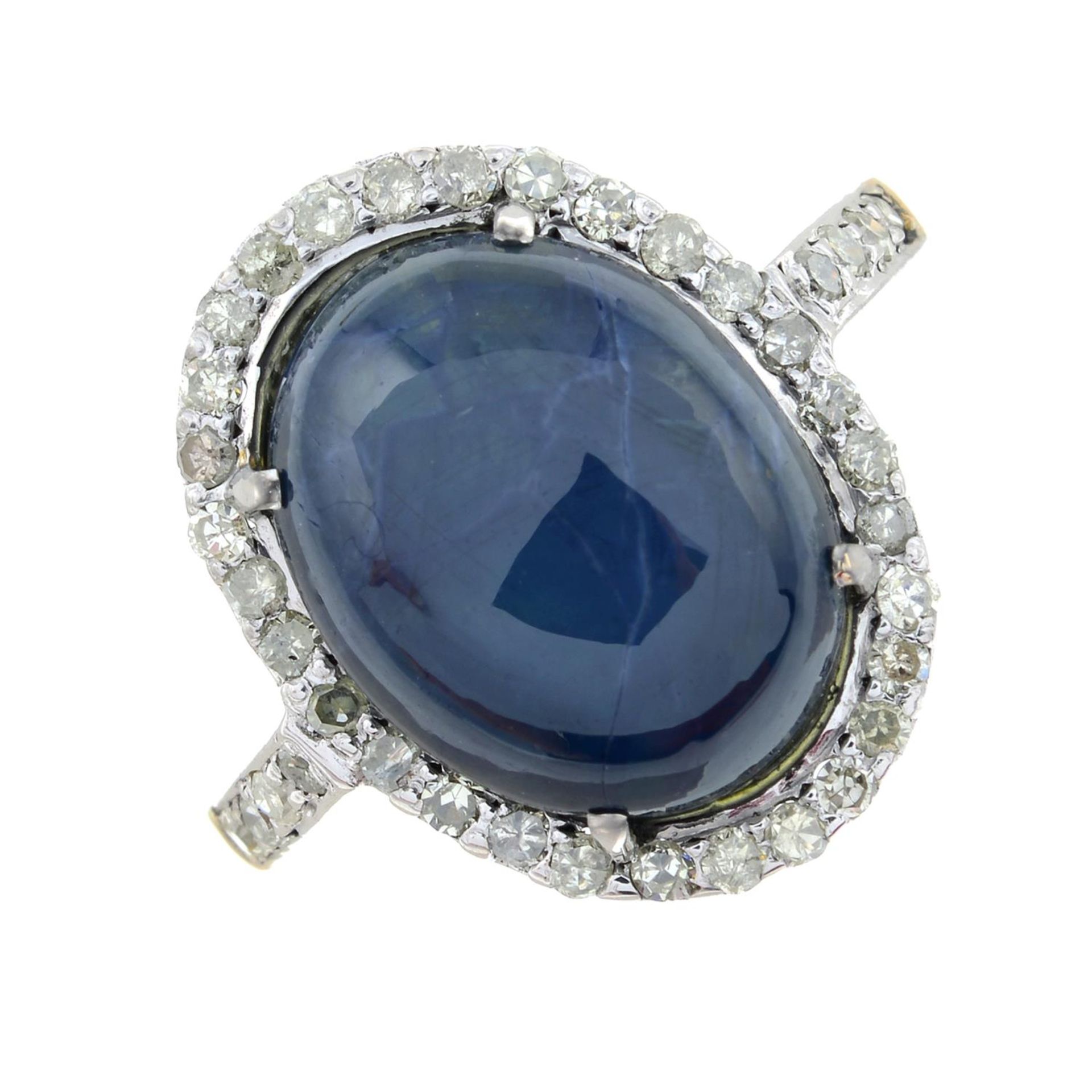 A star sapphire cabochon and single-cut diamond cluster ring.Star sapphire weight 7.52cts.Estimated